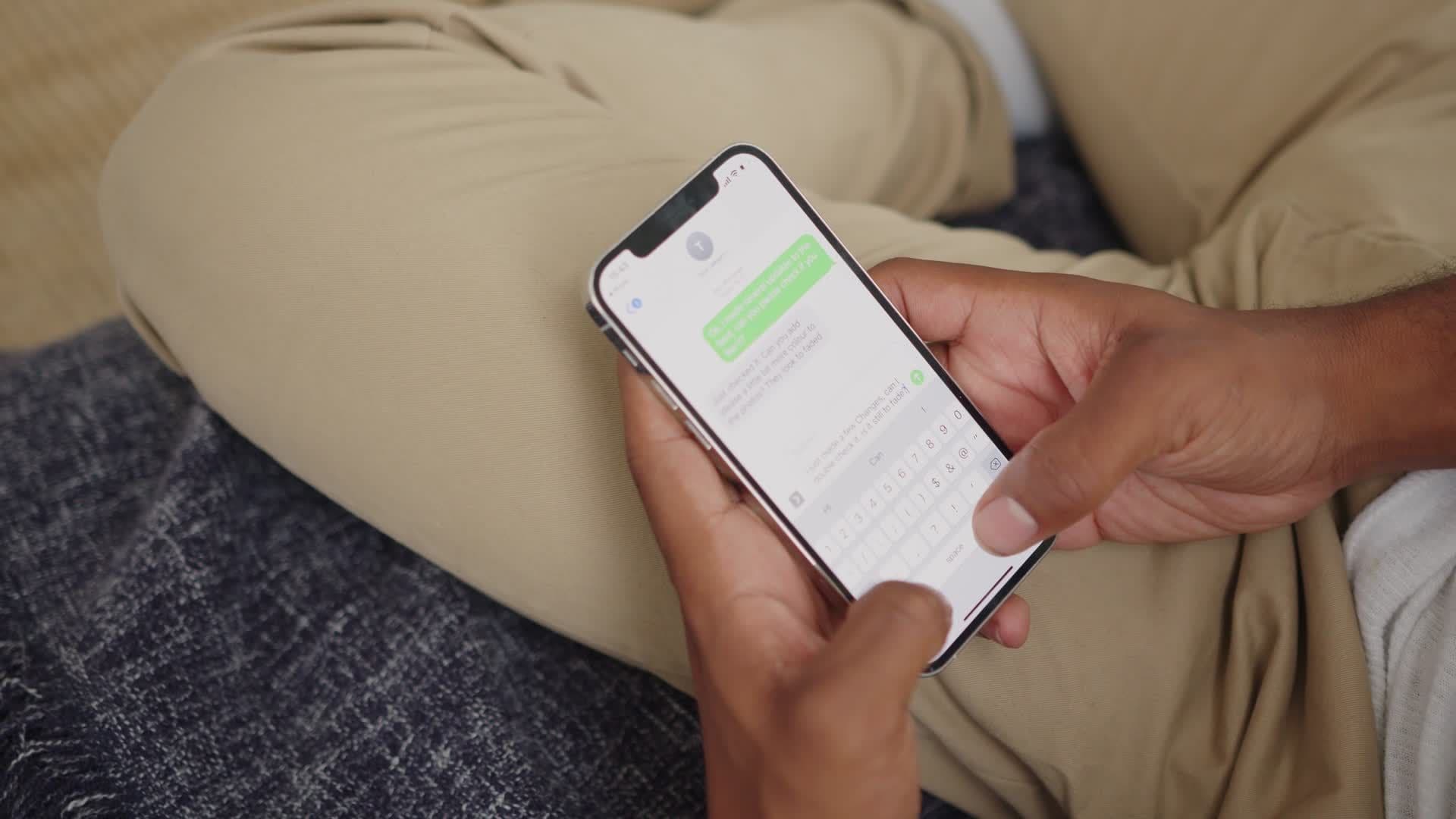A broker typing a question on his phone